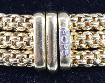 Lot 1309 - A Fope 18ct yellow gold three-strand meshlink...