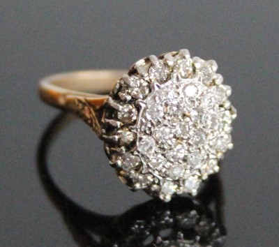 Lot 2846 - A yellow and white metal diamond oval cluster...