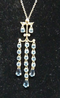 Lot 408 - A modern 9ct gold blue topaz set pendant on...