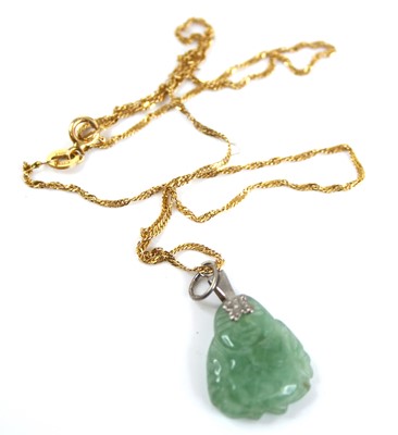 Lot 2414 - A Chinese carved celadon jade pendant as a...