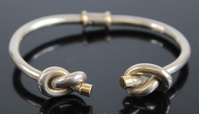 Lot 2440 - A Gucci silver and 18ct gold tipped bangle,...
