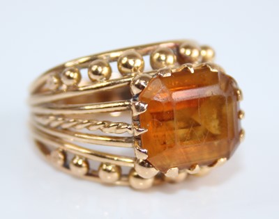 Lot 2430 - A yellow metal and citrine set dress ring, the...