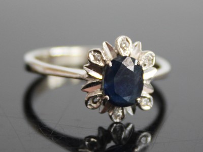 Lot 2470 - A white metal, sapphire and diamond flower...