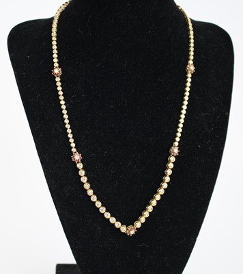 Lot 2256 - An 18ct gold ruby and diamond articulated link...