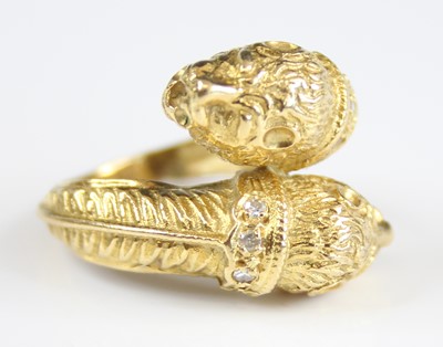 Lot 2244 - A yellow metal double lion head crossover ring...