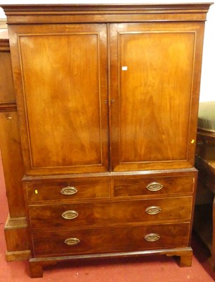 Lot 1176 - An early 19th century mahogany linenpress,...