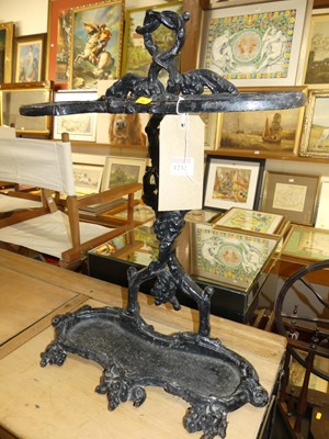 Lot 1232 - A black painted cast iron twin division stick...