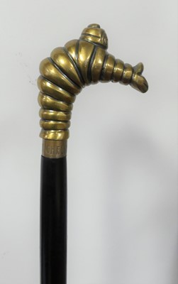 Lot 277 - A walking stick, the brass handle in the form...