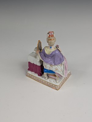 Lot 2066 - A Meissen porcelain figure of a lady sat at...