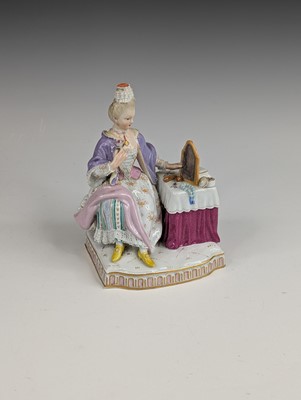 Lot 2066 - A Meissen porcelain figure of a lady sat at...