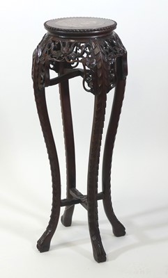 Lot 2454 - A Chinese rosewood jardiniere stand, having a...