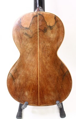 Lot 656 - An acoustic parlour guitar having a walnut...