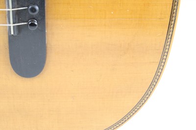 Lot 656 - An acoustic parlour guitar having a walnut...