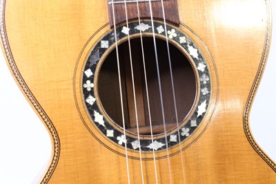 Lot 656 - An acoustic parlour guitar having a walnut...