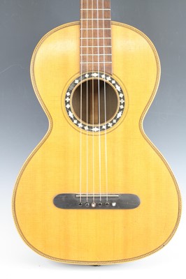 Lot 656 - An acoustic parlour guitar having a walnut...