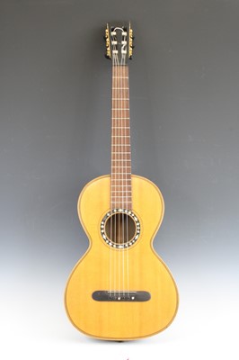 Lot 656 - An acoustic parlour guitar having a walnut...