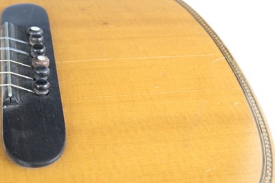 Lot 656 - An acoustic parlour guitar having a walnut...