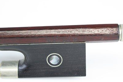 Lot 658 - A violin bow having a nickel adjuster with...