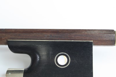 Lot 648 - A violin bow having a nickel adjuster with...