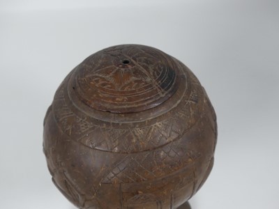 Lot 4 - A coconut cup and cover, relief carved with...
