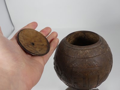Lot 4 - A coconut cup and cover, relief carved with...