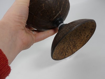Lot 4 - A coconut cup and cover, relief carved with...