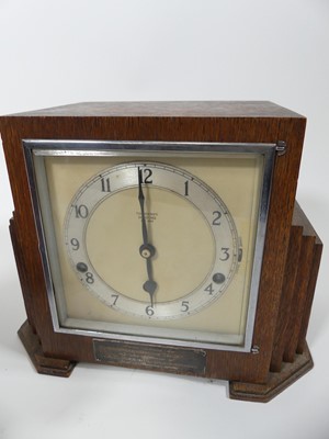 Lot 7 - An Art Deco oak cased mantel clock, having an...