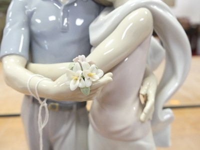 Lot 22 - A Lladro porcelain figure group of a courting...