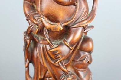 Lot 34 - A Chinese hardwood carving of an immortal...