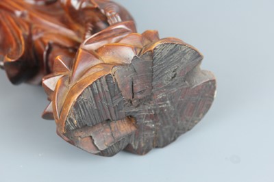 Lot 34 - A Chinese hardwood carving of an immortal...