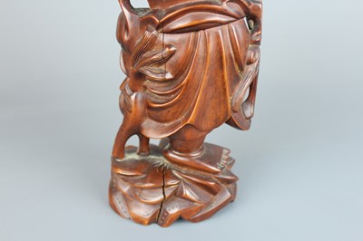 Lot 34 - A Chinese hardwood carving of an immortal...