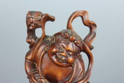 Lot 34 - A Chinese hardwood carving of an immortal...