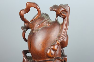 Lot 34 - A Chinese hardwood carving of an immortal...