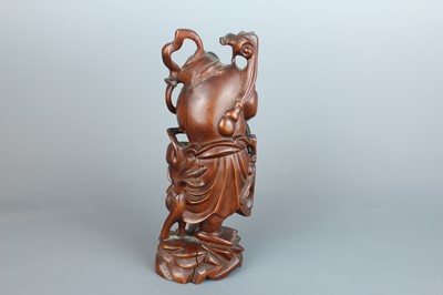 Lot 34 - A Chinese hardwood carving of an immortal...