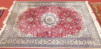 Lot 1171 - A Persian wool rug with fine weave in red,...