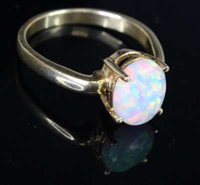 Lot 351 - A modern 14ct gold and opal set dress ring,...