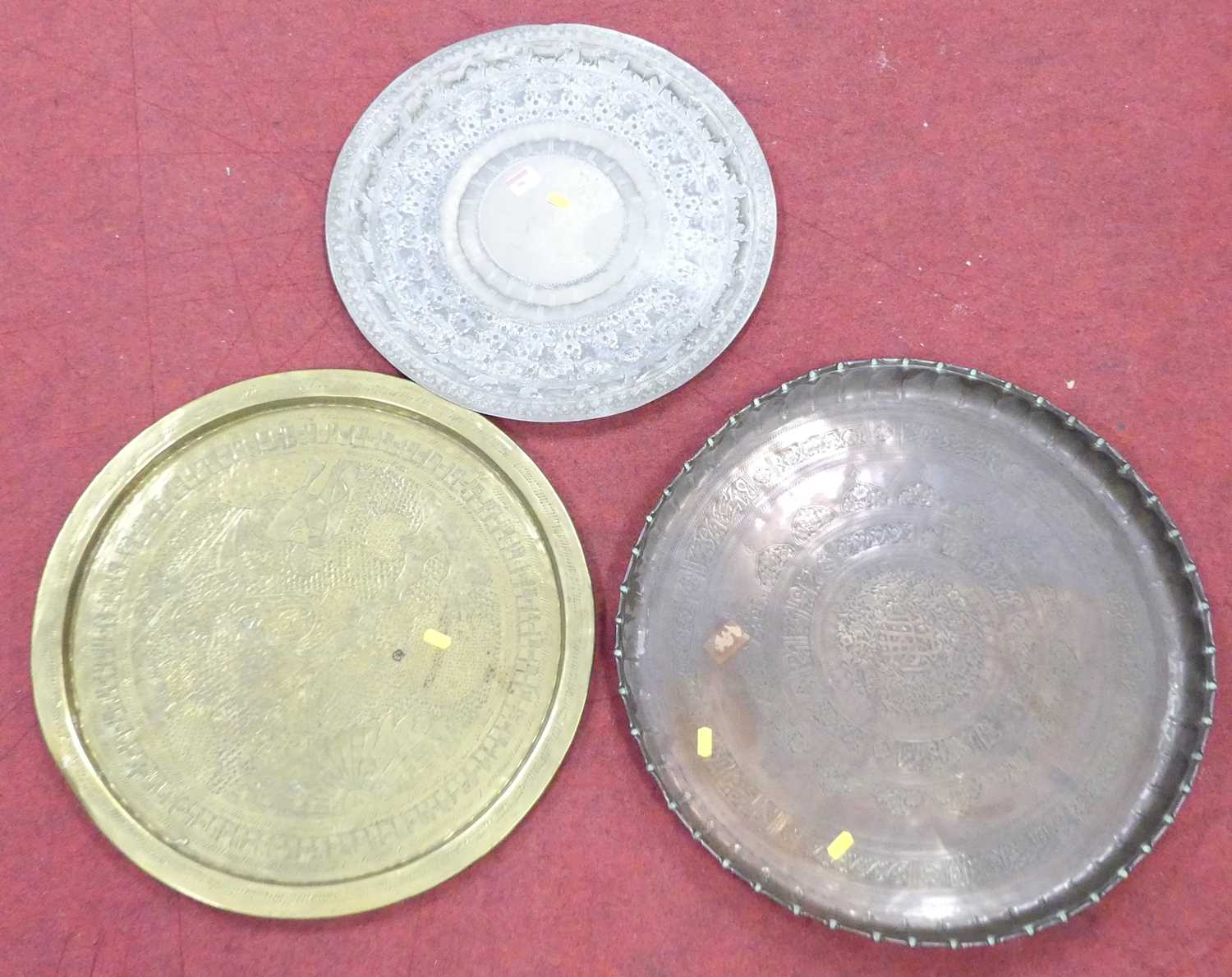 Lot 190 - An Indian brass charger, dia.55cm; together...