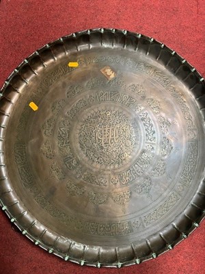 Lot 190 - An Indian brass charger, dia.55cm; together...