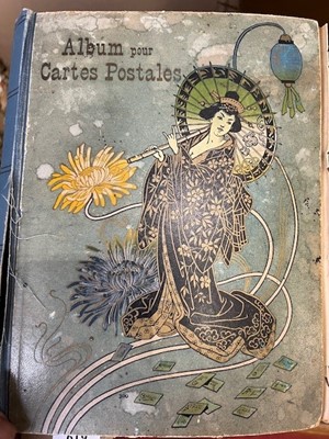 Lot 619 - An early 20th century postcard album &...