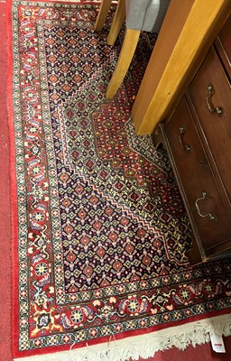 Lot 1155 - A Persian woollen red ground Bidjar rug with...