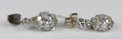 Lot 2276 - A pair of white metal diamond drop earrings,...