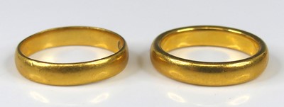 Lot 2254 - A 22ct gold court shaped wedding band, Chester...