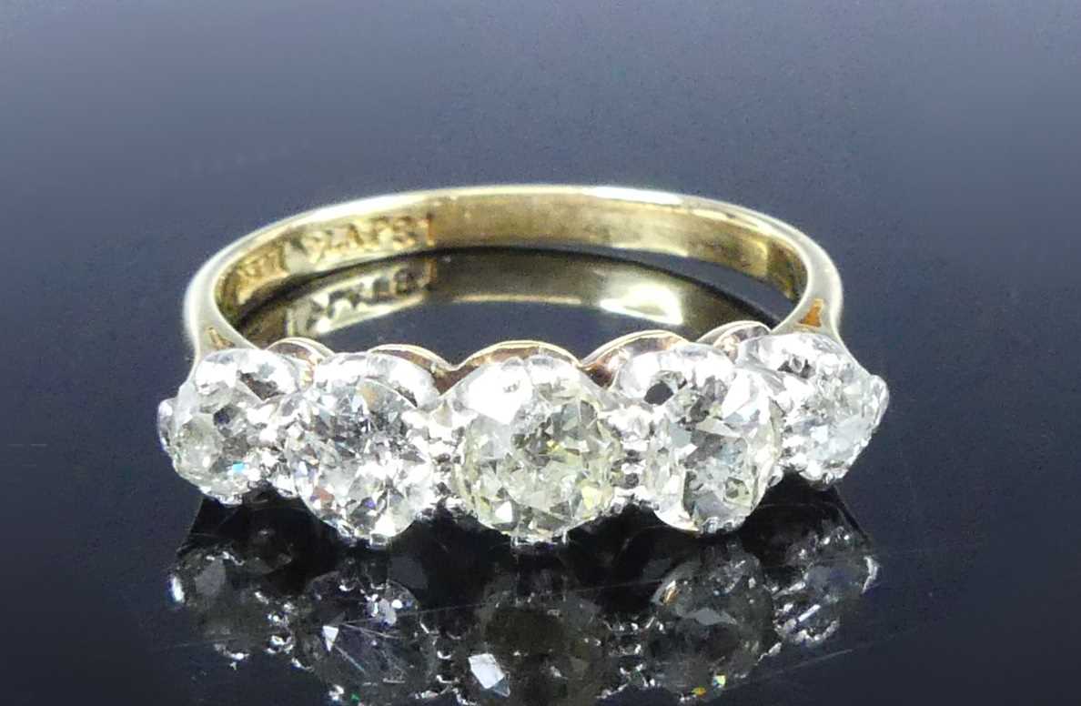 Lot 2539 - A yellow and white metal diamond half eternity...