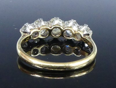 Lot 2539 - A yellow and white metal diamond half eternity...