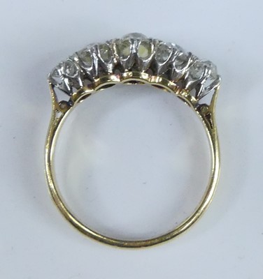 Lot 2539 - A yellow and white metal diamond half eternity...