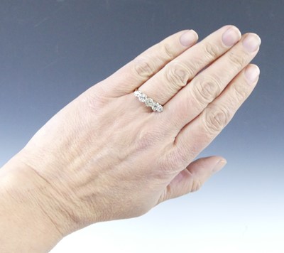 Lot 2539 - A yellow and white metal diamond half eternity...