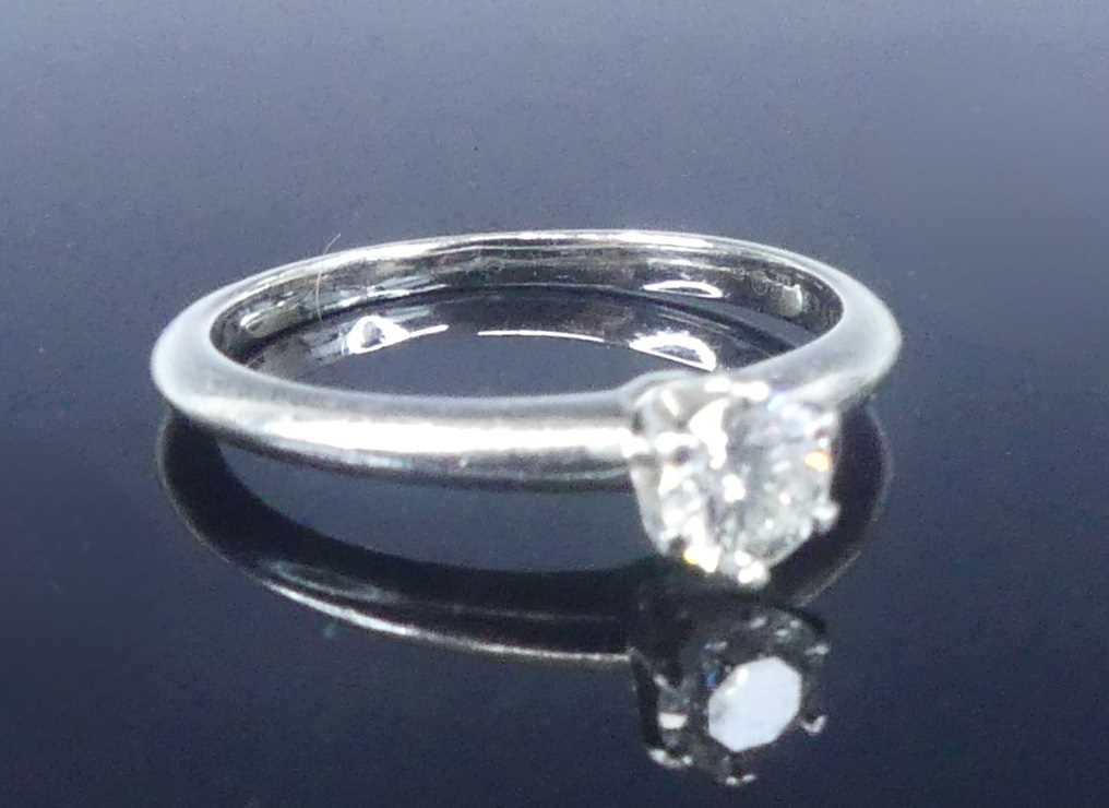Lot 2565 - A Tiffany platinum diamond solitaire ring,...