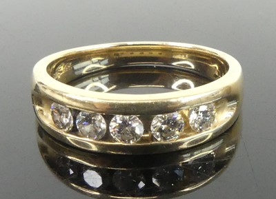 Lot 2630 - A yellow metal diamond half eternity ring,...