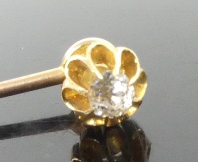 Lot 2606 - A yellow metal diamond stick pin, featuring an...