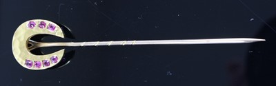Lot 442 - A yellow metal horseshoe tie-pin, the...